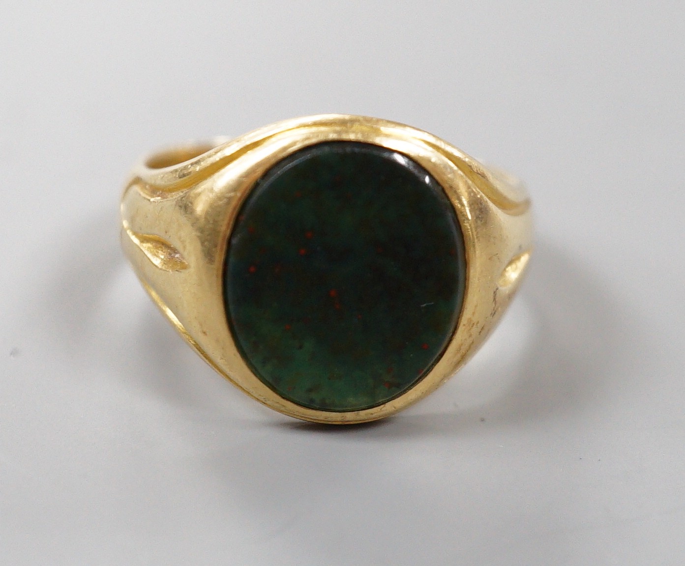 A late Victorian 18ct gold and oval bloodstone set signet ring, size O, gross weight 6.9 grams.